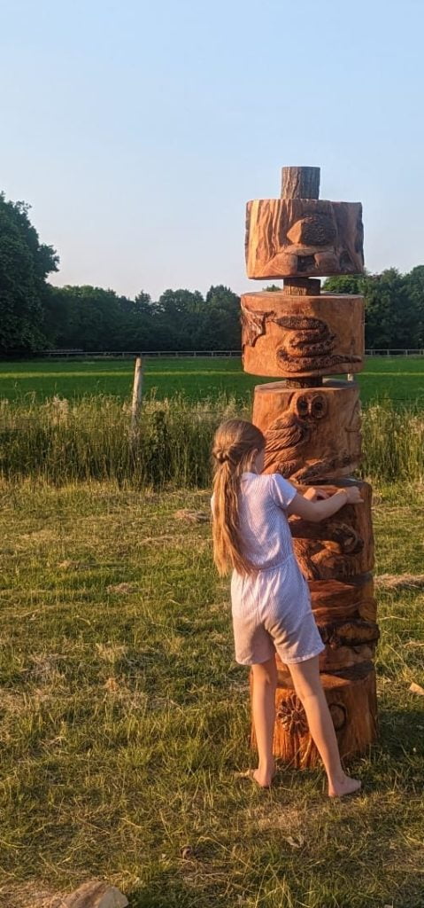 Image of totem pole with child